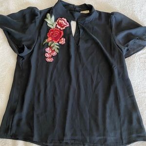 Women’s Blouse with red and green floral patch.